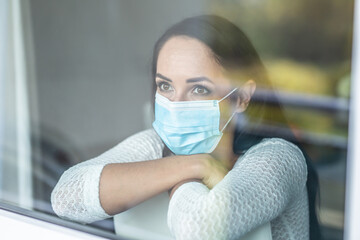 Quarantine measures of a woman with mild symptoms, wearing face mask even in isolation