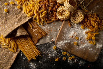 Different types of pasta. The pasta is on the table. Raw pasta. Texture.