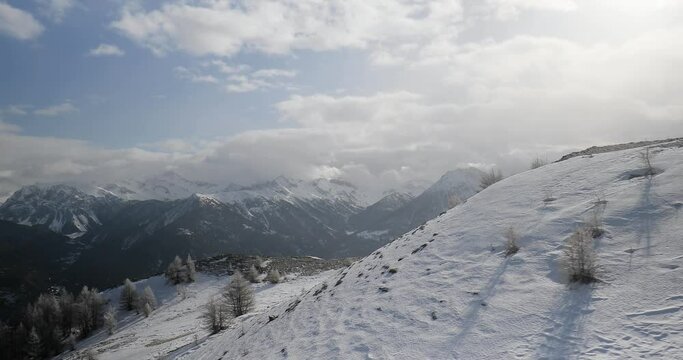 Snowy alpine landscape with falling snow from an ascending ski lift