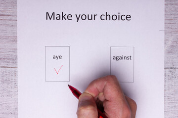 man fills out a voice sheet making a choice
