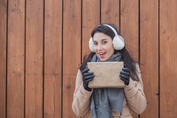 woman in earmuffs with gift close up portrait 
