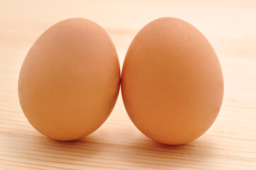 Fresh eggs on a wooden table.