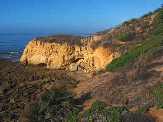 Hinking at the beach of Praia Maria Luisa, Olhos da Agua, Albufeira, at the Algarve coast of Portugal