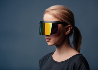 Woman in futuristic glasses on grey background