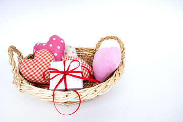 Gift basket and hearts isolated on a white background. The concept of gifts and congratulations for the holidays. Copy space.