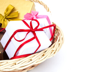Fototapeta na wymiar Gift basket isolated on a white background. The concept of gifts and congratulations for the holidays. Copy space.