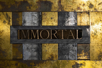 Immortal text message on textured grunge copper and vintage gold background