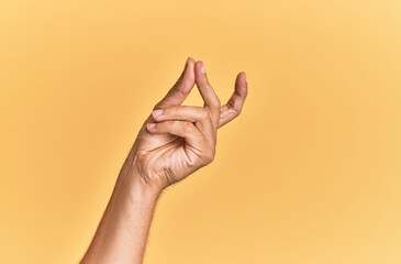 Arm and hand of caucasian man over yellow isolated background snapping fingers for success, easy...