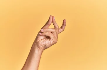 Poster Arm and hand of caucasian man over yellow isolated background snapping fingers for success, easy and click symbol gesture with hand © Krakenimages.com