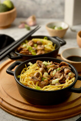 Egg noodles in black bowls, asian food