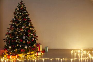 Christmas tree pine with gifts light garlands interior decor new year