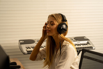 young attractive Caucasian woman musical sound composer  in recording studio with microphone....