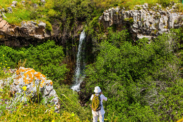 Woman in white hat photographs