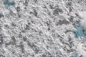 Ice surface with large fluffy snowflakes, natural organic background, top view