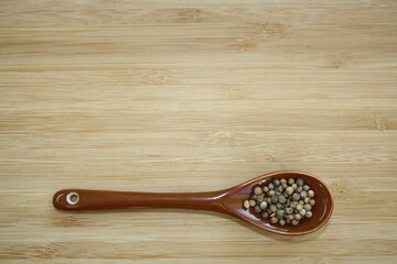 Spice coriander in a ceramic spoon.