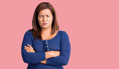 Fototapeta premium Middle age latin woman wearing casual clothes skeptic and nervous, disapproving expression on face with crossed arms. negative person.