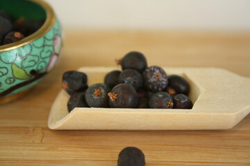 Wooden spoon with juniper berries.