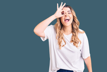 Fototapeta na wymiar Young caucasian woman wearing casual clothes doing ok gesture with hand smiling, eye looking through fingers with happy face.