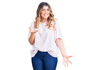 Fototapeta na wymiar Young caucasian woman wearing casual clothes smiling cheerful with open arms as friendly welcome, positive and confident greetings