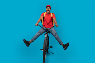Funny delivery delivery man riding bicycle at studio
