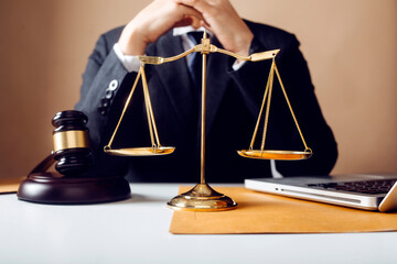 Business and lawyers discussing contract papers with brass scale on desk in office. Law, legal...