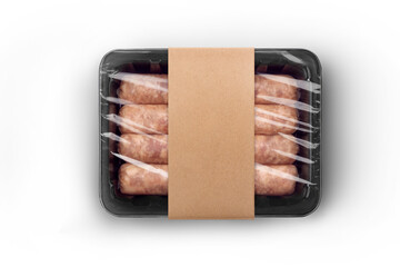 Sealable black plastic tray of fresh raw sausages with craft paper label isolated on white...