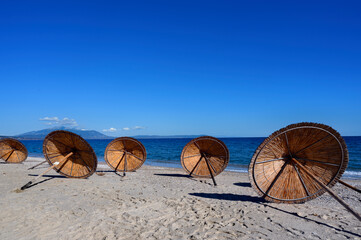 Sun umbrellas left at the beach in Asprovalta, Greece