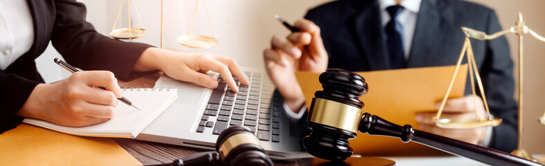 Business and lawyers discussing contract papers with brass scale on desk in office. Law, legal...