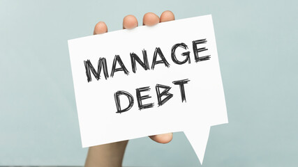 Manage debt text - motivational reminder handwritten on sticky note