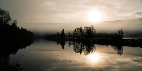 The mist is leaving and the sun is rising. Autumn in the Hemsedal in Norway mountains. Shot with long exposure.