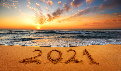 Happy New Year 2021! Written 2021 on the beach. Happy New Year 2021 is coming concept sandy.