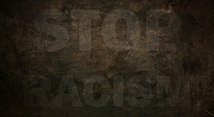 Font with transparency STOP RACISM graffiti on a black stone background. copy space