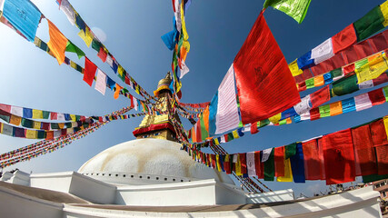 The Bouddhanath Temple in Kathmandu, Nepal. The temple has many colourful prayer flags with 'om...