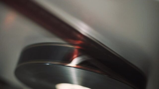 16 mm film tape that is wound on a roll