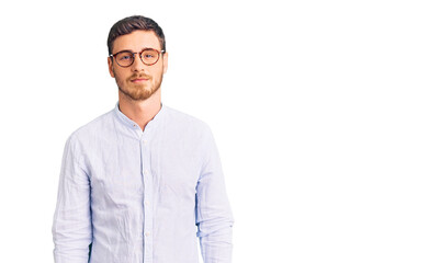 Fototapeta premium Handsome young man with bear wearing elegant business shirt and glasses relaxed with serious expression on face. simple and natural looking at the camera.