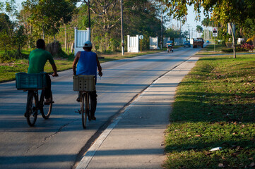 Men on bicycles returning from work on the streets of a city
