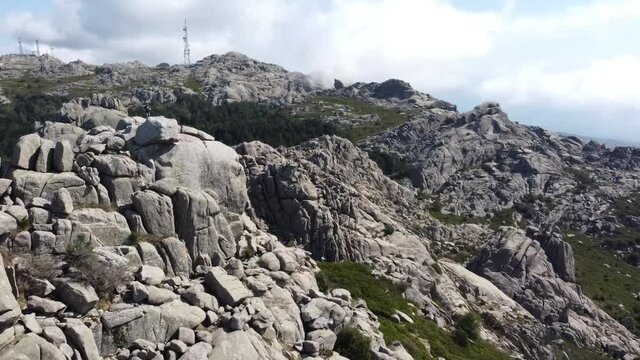 drone circle around a guy standing on the top of Monte Limbara in Sardinia's north