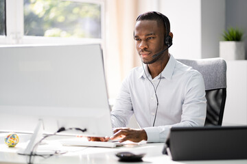 Business Service Agent With Headset At Computer