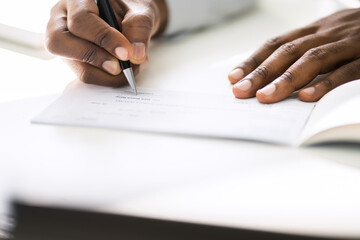 African American Writing Cheque. Signing Paycheck