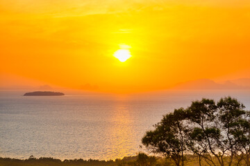 Fototapeta na wymiar Many small islands landscape on sunset sea with colorful sunset sky and green trees