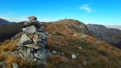 Small tower of stones on the mountain peak
