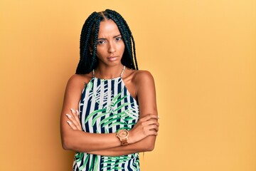 Beautiful hispanic woman wearing summer dress skeptic and nervous, disapproving expression on face...