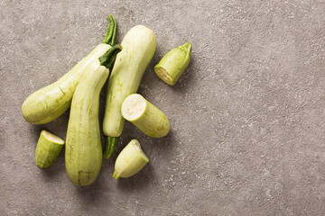 Zucchini seasonal dietary vegetable in colo-slag on gray concrete background, copy space