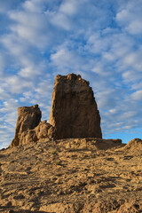 Fototapeta premium Roque nublo photographed at sunset with a slightly cloudy blue sky.