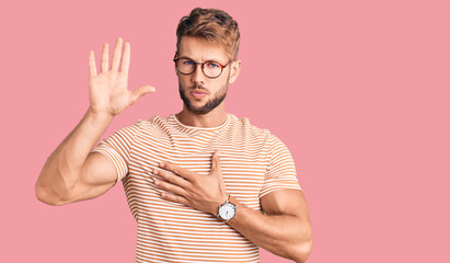 Young caucasian man wearing casual clothes and glasses swearing with hand on chest and open palm,...