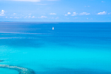 Watercolor drawing of Aerial view of beautiful amazing Tyrrhenian sea with turquoise water, tropical seascape with blue sky white clouds, small yacht background, Tropea, Calabria, Southern Italy