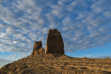 Fototapeta na wymiar Roque nublo photographed at sunset with a slightly cloudy blue sky.