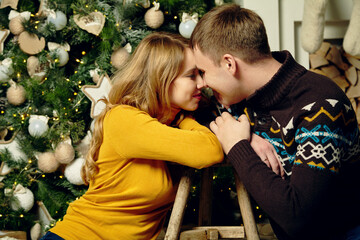 young couple celebrating Christmas at home. man and woman on New Year Eve.