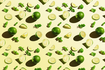 Seamless texture of lime with mint on yellow background. Top view.