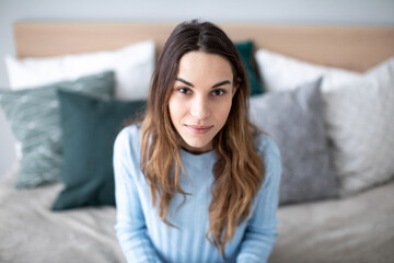 Portrait beautiful woman look at camera on couch.